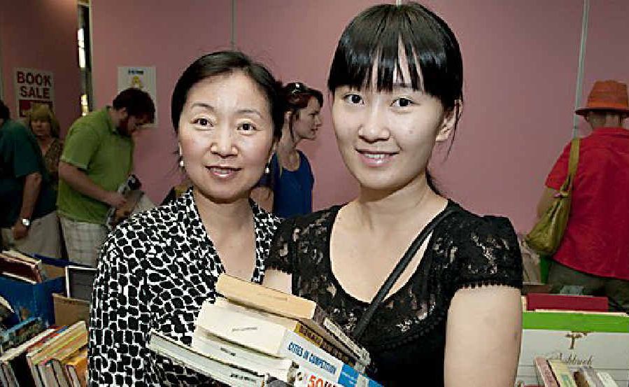 Browsing the aisles of books yesterday were (from left) Jing Lin and Nancy Wang.